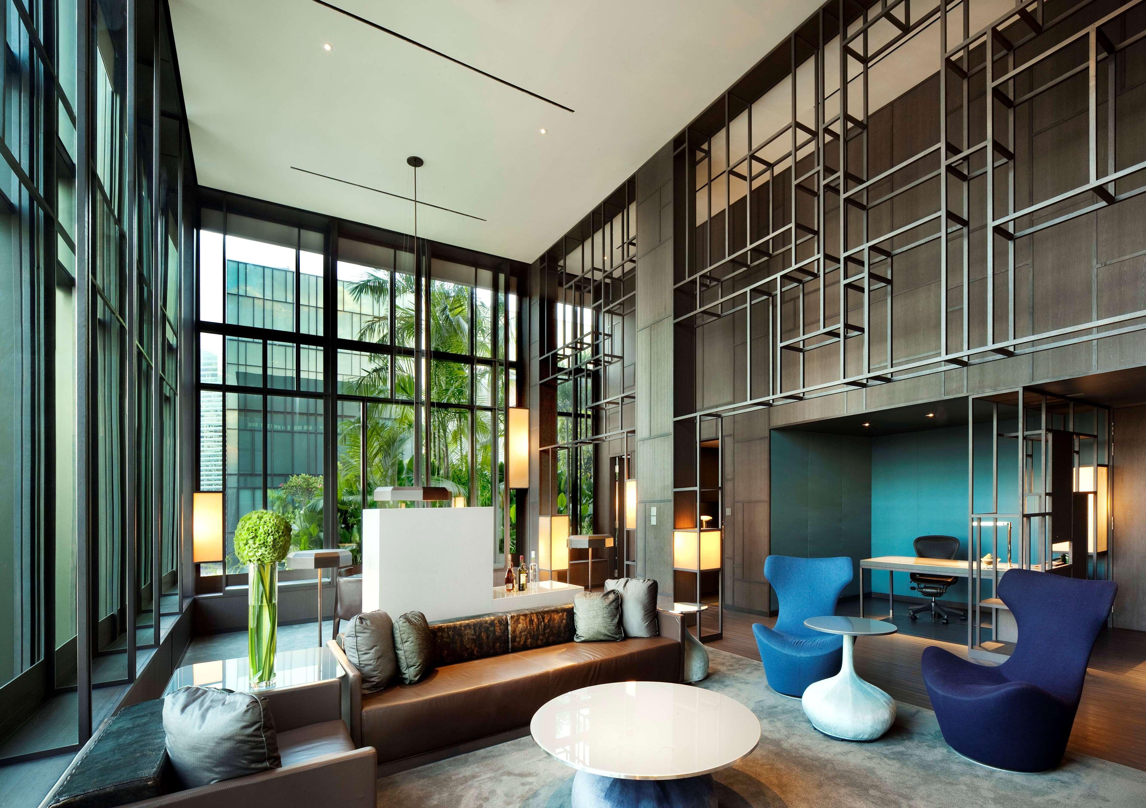 Parkroyal Collection Pickering, Сингапур Екстериор снимка The photo shows a modern lobby or lounge area. It features large windows that allow plenty of natural light to flood the space, creating an open and airy atmosphere. The interior design includes a combination of comfortable seating arrangements with 